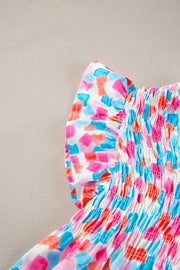 Smocked bodice blouse with brushstroke print in pink, blue, and coral.