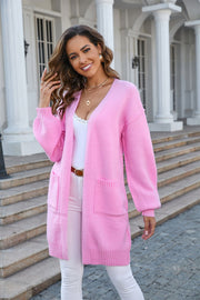 Pink slouchy knit cardigan with pockets and V-neck, acrylic material.