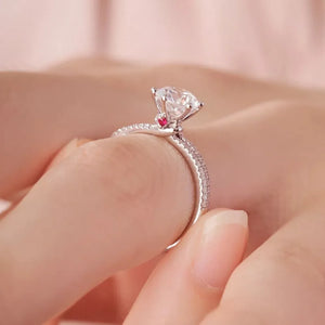 Timeless Moissanite Ring in Sterling Silver with pave band and red accent stone.