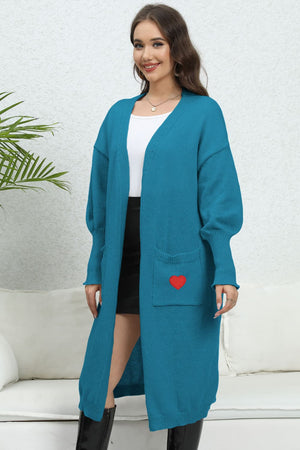 Cerulean long cardigan with balloon sleeves and a red heart embroidered pocket detail.