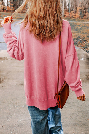 Oversized washed cotton sweatshirt in carnation pink with side slits and crew neck.