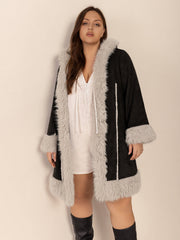 Black hooded duster coat with faux shearling trim and cuffs.