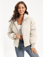 Cream padded bomber jacket with ribbed cuffs and collar, zip front.