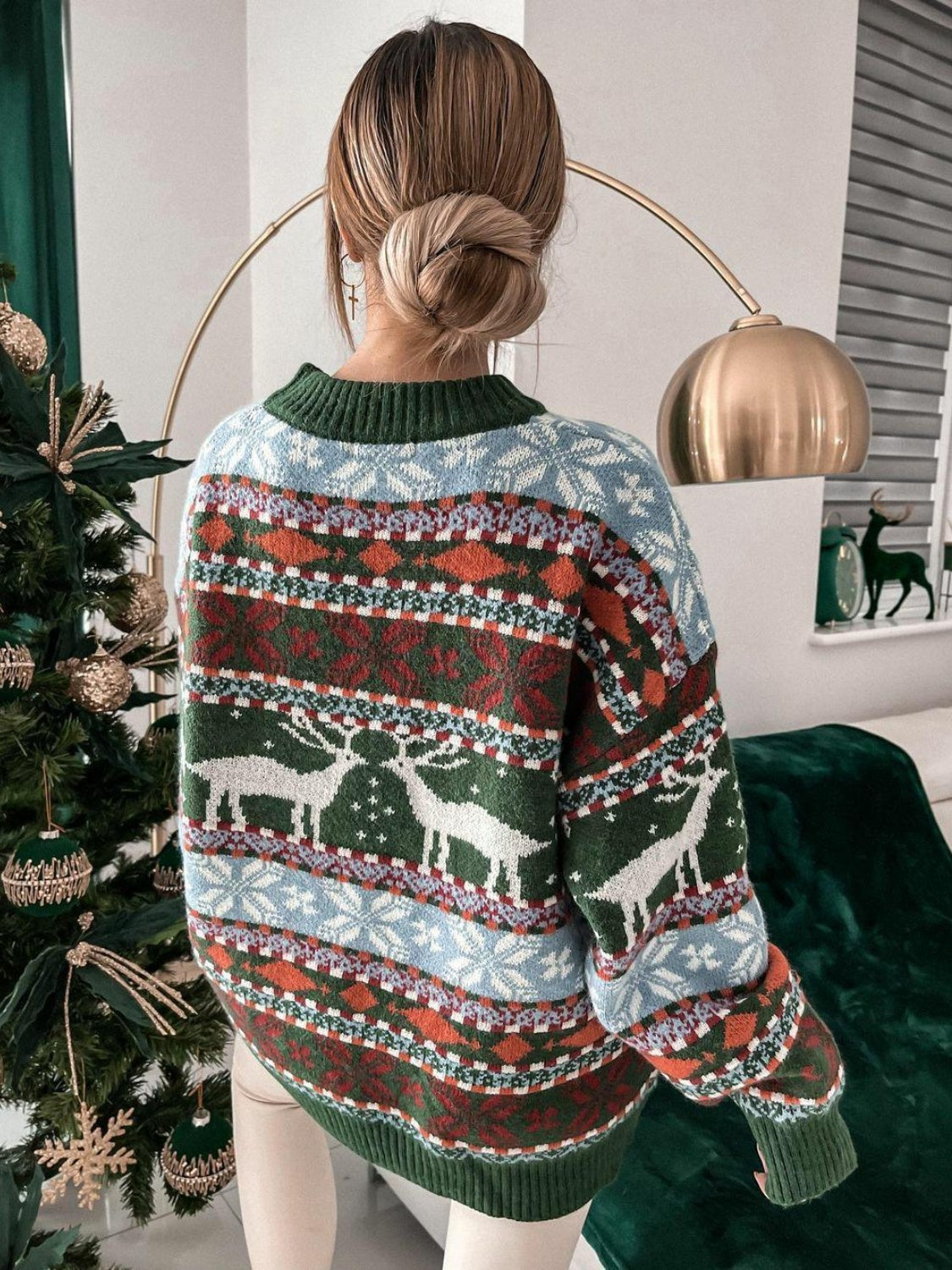 Fair Isle reindeer motif knit sweater with a crew neck and long sleeves in green.