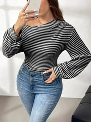Black and white striped maternity t-shirt with one-shoulder neckline and balloon sleeves.