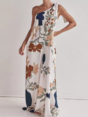 Elegant one-shoulder maxi dress with a floral print and tie detail.
