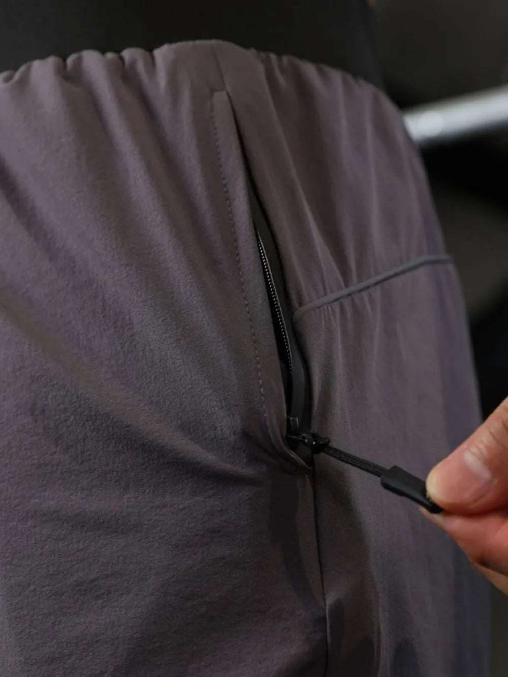 Dark Gray Gymbull performance shorts with zippered pocket detail