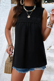 Black textured yoke dot tank top with smocked neckline and lace trim.
