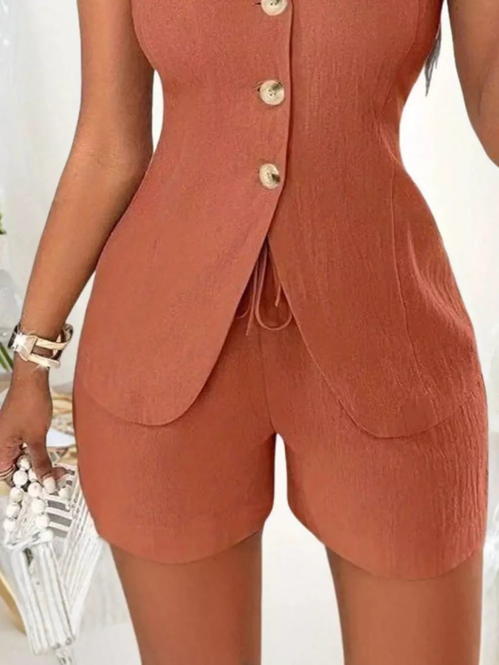 Apricot button-down vest and shorts set with drawstring detail.
