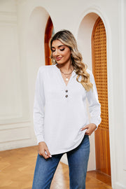 White long sleeve henley top with button detail and v-neck