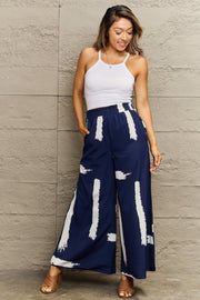 Navy palazzo trousers with white brushstroke pattern and wide legs