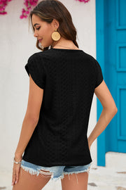 Black cap-sleeve blouse with textured pattern and keyhole neckline detail.
