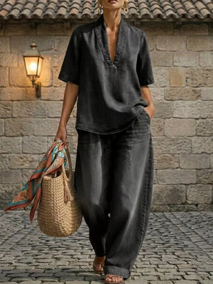 Black V-neck top and wide-leg cotton pants set with cuffed ankles.