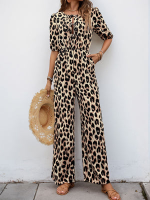 Leopard print jumpsuit with puff sleeves and tie-front neckline, wide leg.