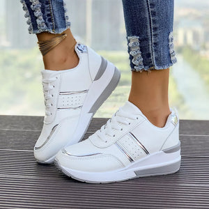 White lace-up sneakers with metallic accents and a chunky sole.