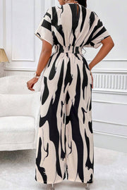 Abstract brushstroke wide-leg jumpsuit in black and taupe with short sleeves and elastic waist.