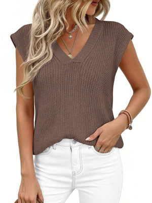 Textured brown V-neck sweater vest with cap sleeves, styled with white jeans.