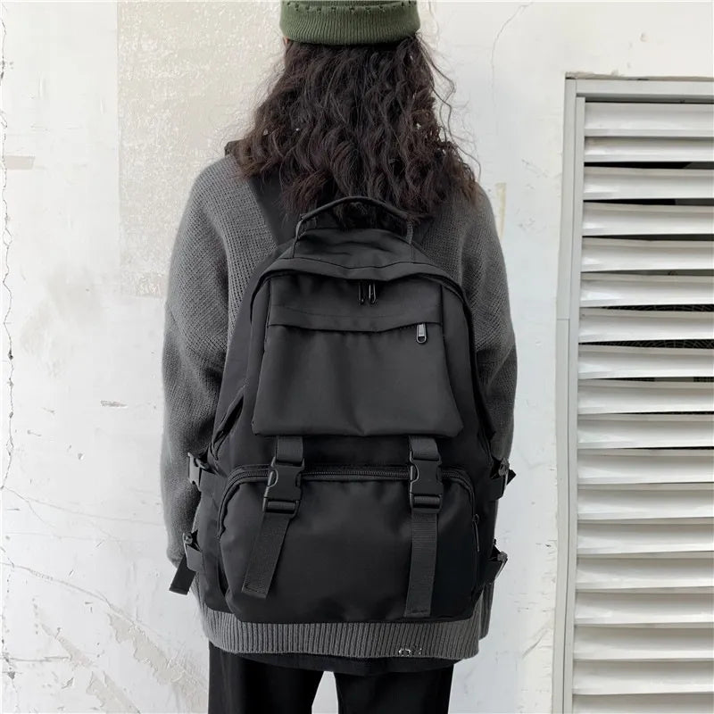 Black utility buckle backpack with multiple pockets and adjustable straps.