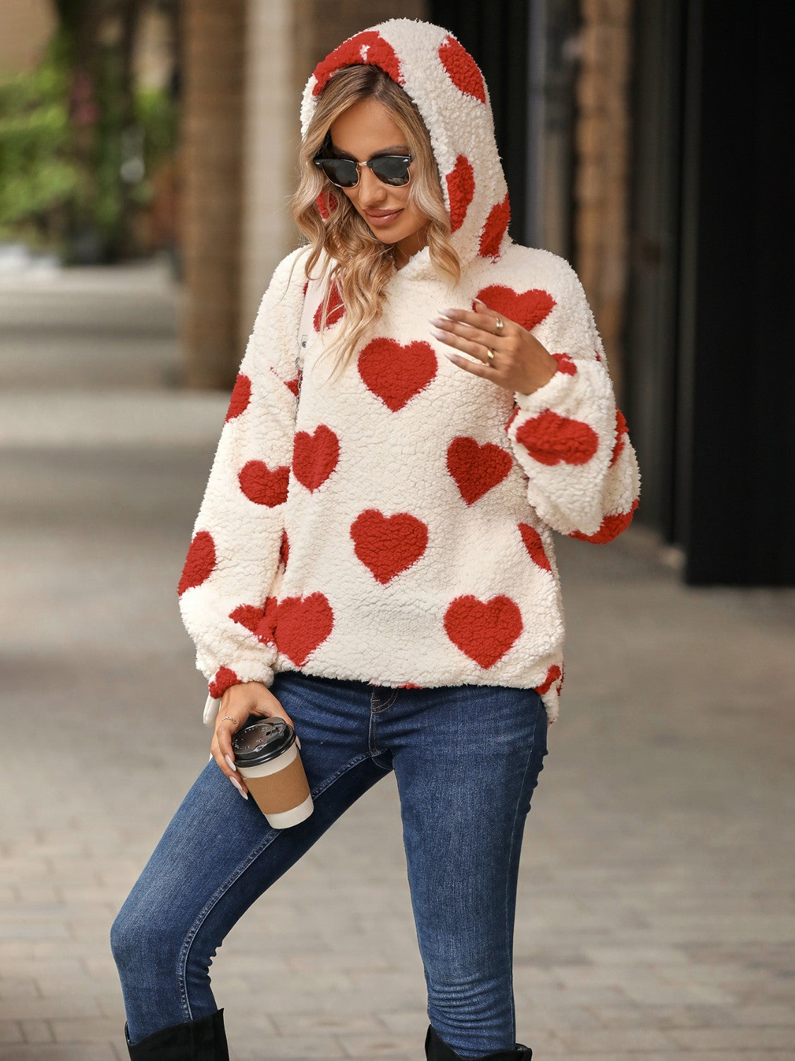 Cream sherpa hoodie with red heart print and hood.