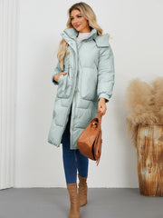 Sage quilted puffer parka with buckle detail and large pockets.