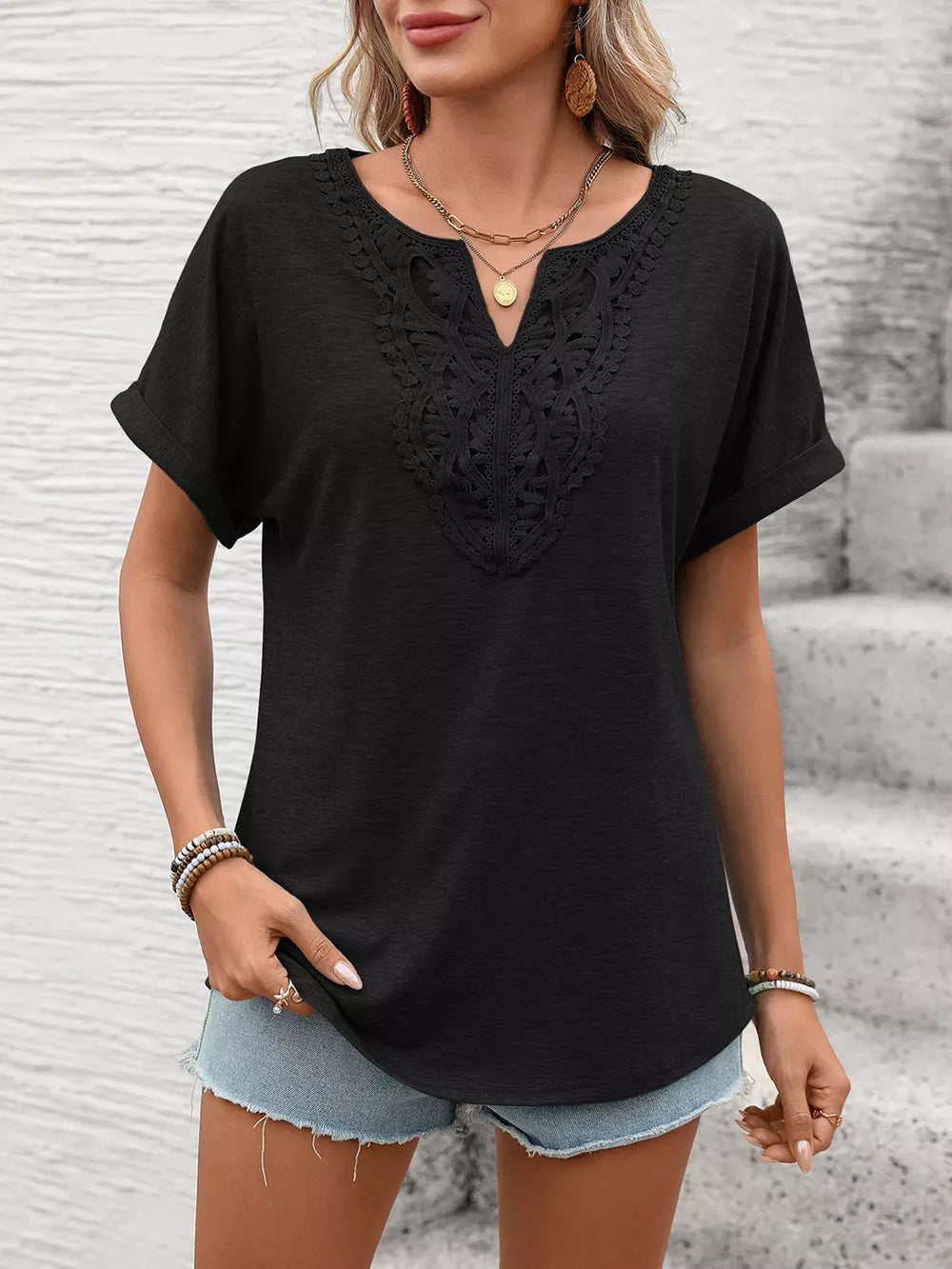 Black relaxed fit t-shirt with lace trim neckline and cuffed short sleeves.