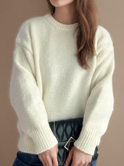 Oversized cream crewneck sweater with textured knit and ribbed cuffs.