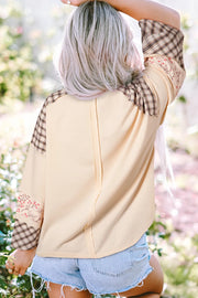 Patchwork heart raglan top in tan with plaid and floral sleeve details.
