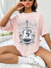 Blush pink oversized graphic tee with Nashville Music City guitar and skyline design.