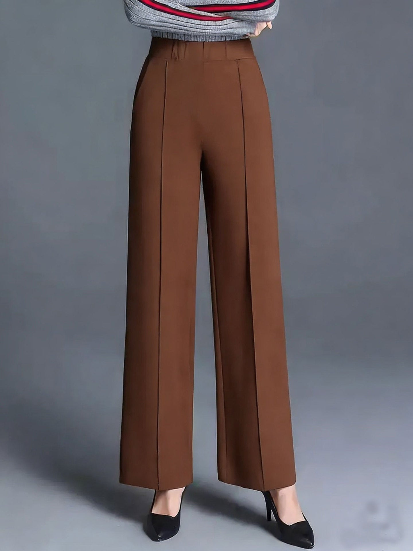 Brown high-waisted wide leg cotton trousers with front pleats and pockets.