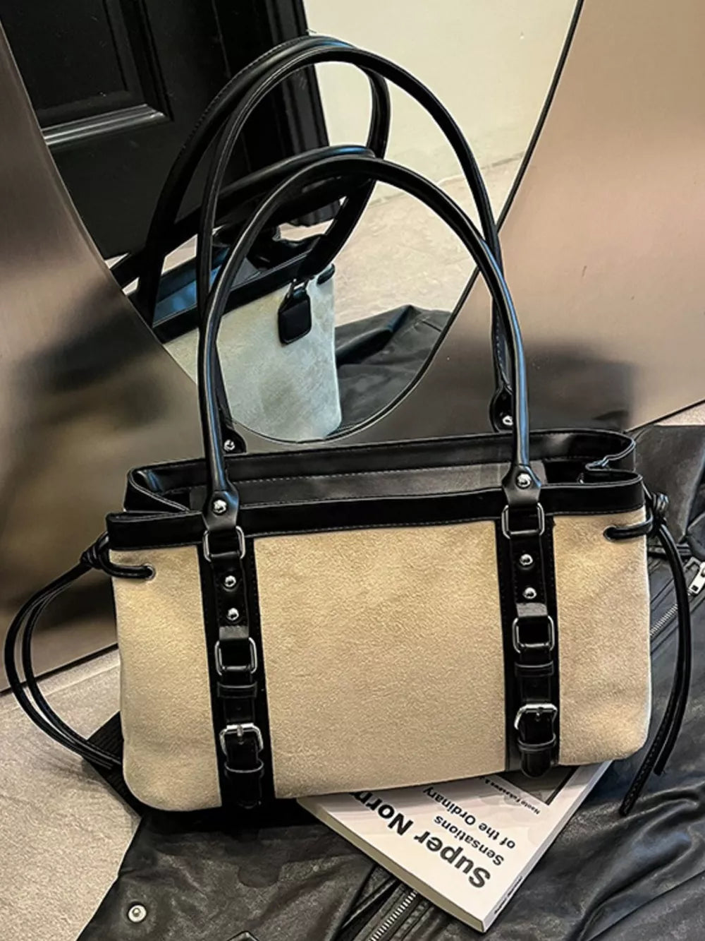 Two-tone suede tote bag with black leather trim and buckle details.