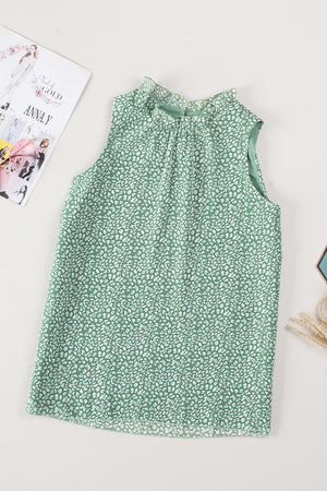 Sage green sleeveless blouse with white leopard print and ruffled neckline.