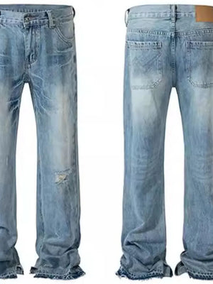 Split-hem distressed denim jeans in medium wash with ripped details and frayed hems.