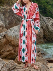 Boho print maxi beach cover-up with tie waist and V-neck in red and green geometric pattern.