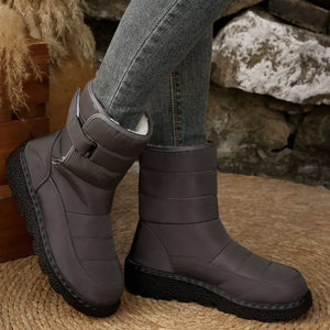 Gray quilted round toe platform boots with adjustable strap and chunky sole.