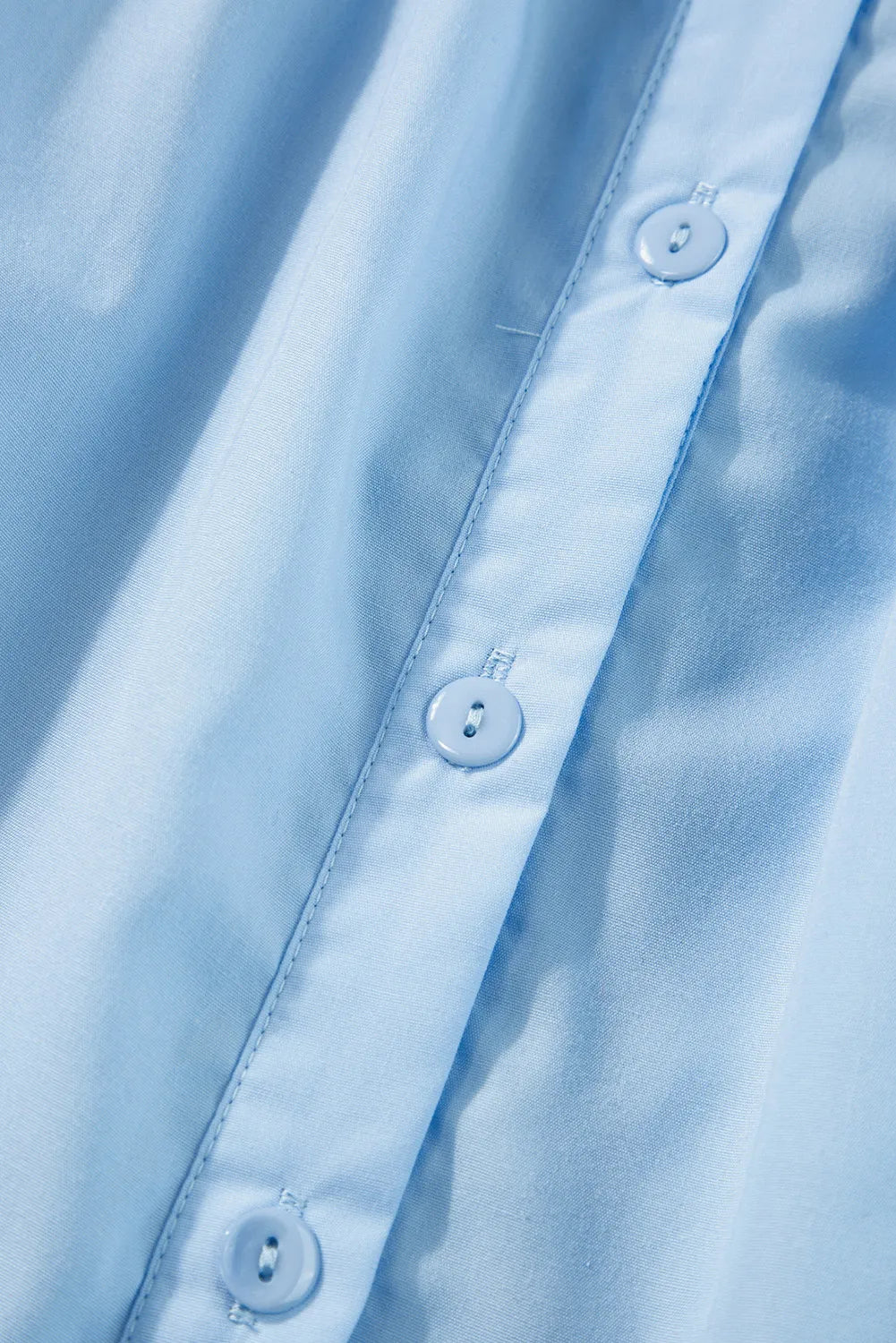 Light blue poplin blouse with button front detail