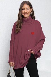 Burgundy knit turtleneck sweater with batwing sleeves and embroidered red heart detail.