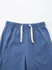 Baby blue cotton shorts with elastic waist and white drawstring detail.