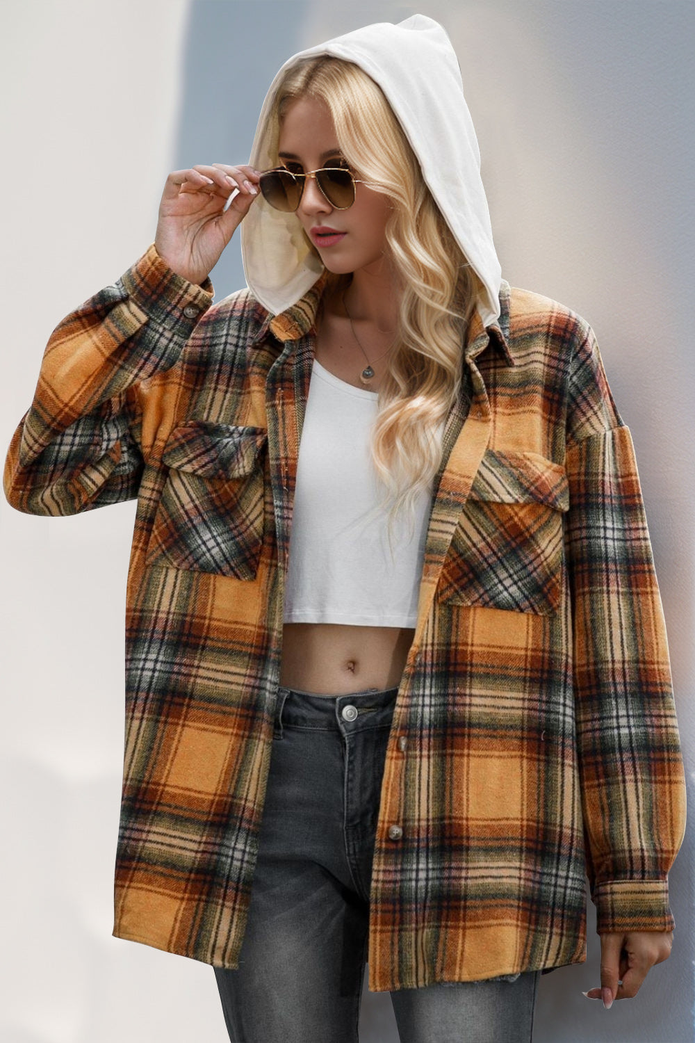 Oversized hooded shirt jacket in sherbet plaid with buttoned front and chest pockets.