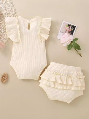 Ribbed baby set in cream with ruffled sleeves and bloomers.