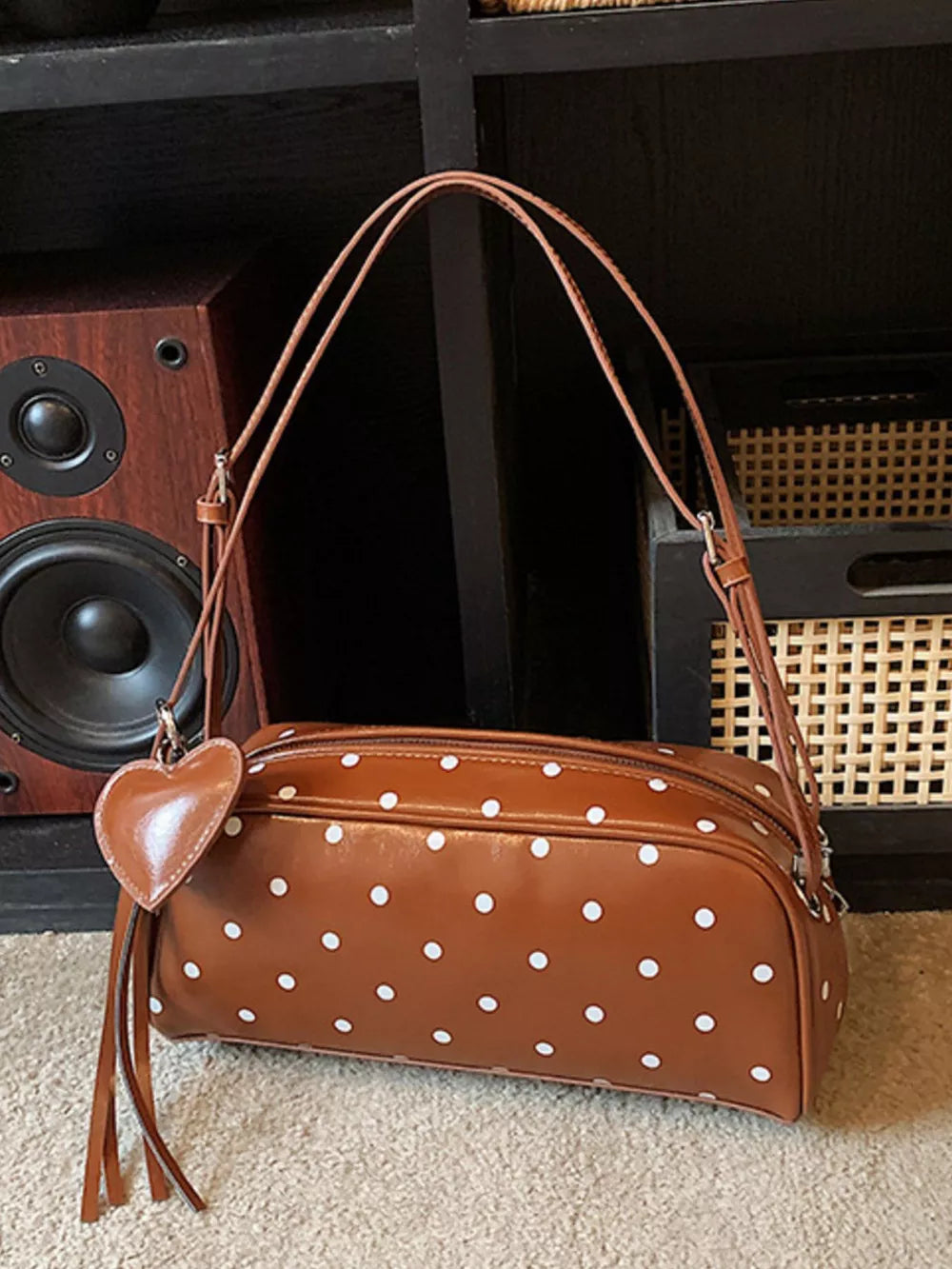 Brown polka dot shoulder bag with heart charm and tassel detail