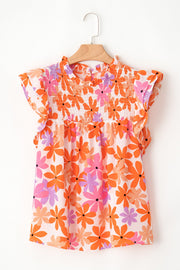 Multicolor floral smocked bodice blouse with flutter sleeves and ruffled neckline.