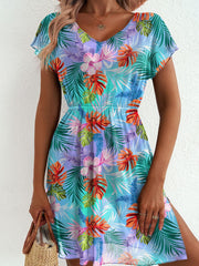 Vibrant leaf print mini dress in sky blue with V-neck, short sleeves, elastic waist, and side slit.