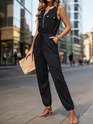 Black utility jumpsuit with zip-front, drawstring waist, and cuffed ankles.