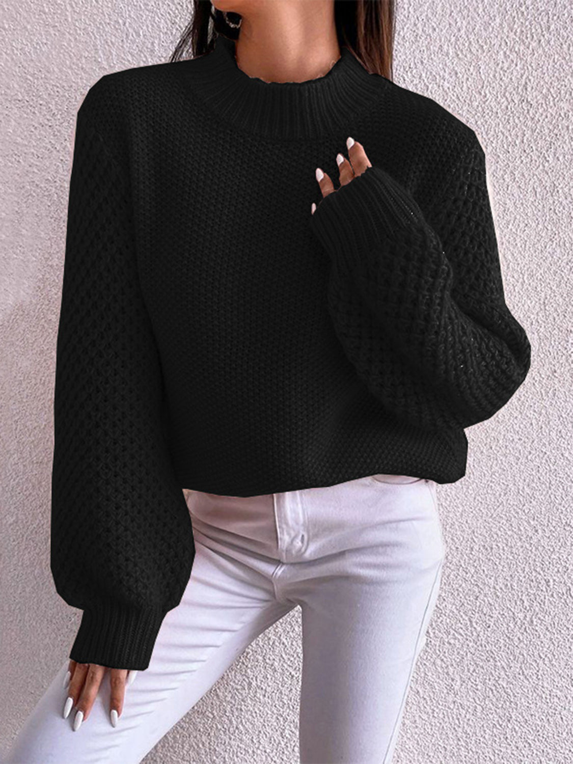 Black textured puff sleeve mock neck knit sweater with ribbed cuffs and hem.