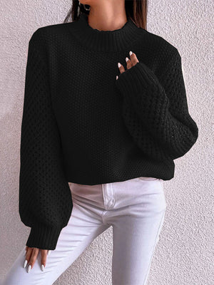 Black textured puff sleeve mock neck knit sweater with ribbed cuffs and hem.