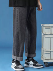 Men's relaxed fit cuffed hem jeans in black denim, shown with rolled cuffs.