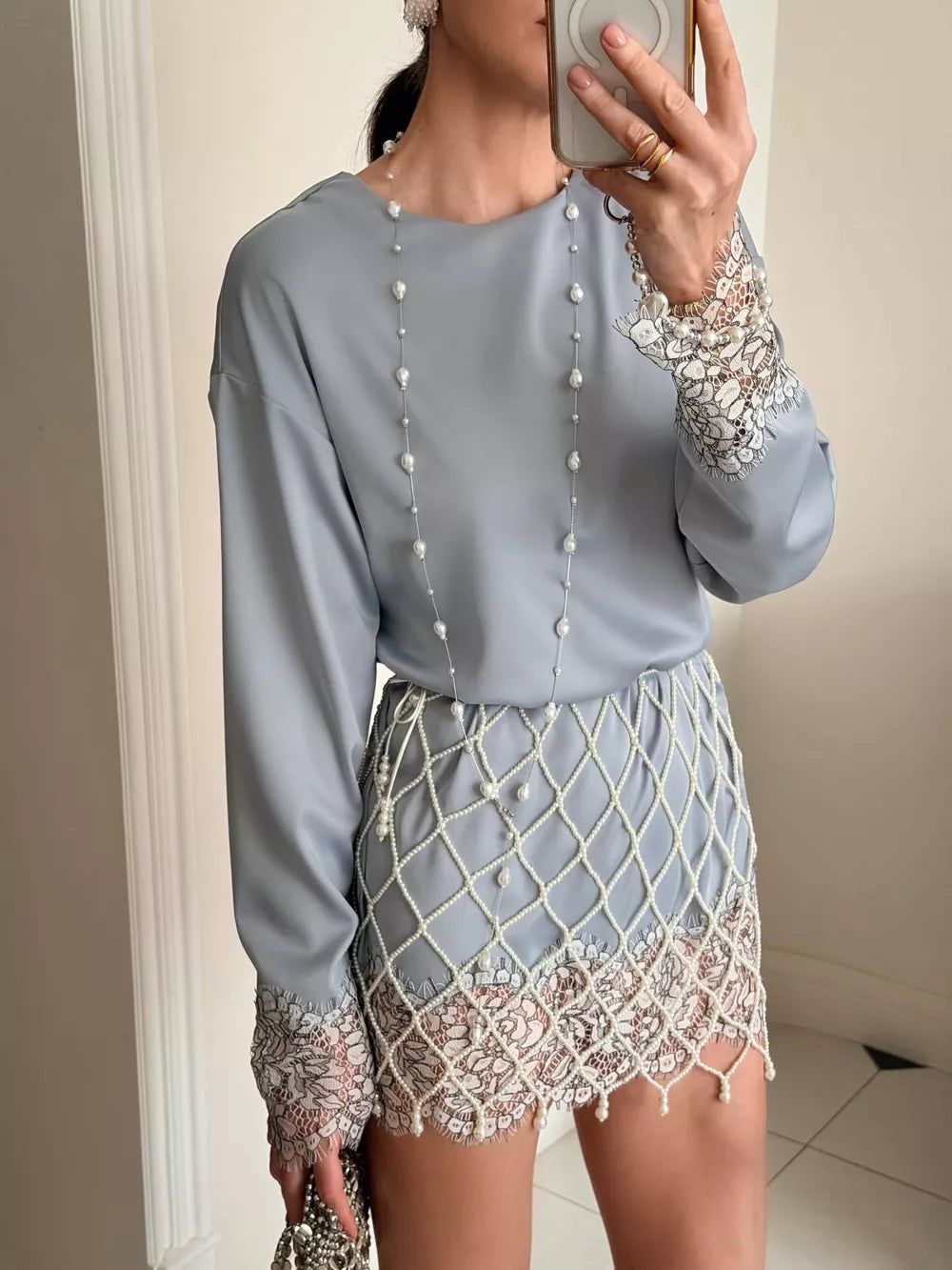Light blue satin oversized t-shirt with lace cuffs and pearl trim skirt.