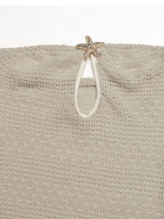 Beige knit maxi dress with cutout detail and starfish embellishment.