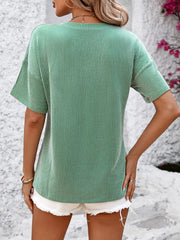 Mid green ribbed V-neck t-shirt with vertical stripes and short sleeves.