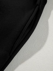 Black cotton joggers with drawstring detail and textured side panel